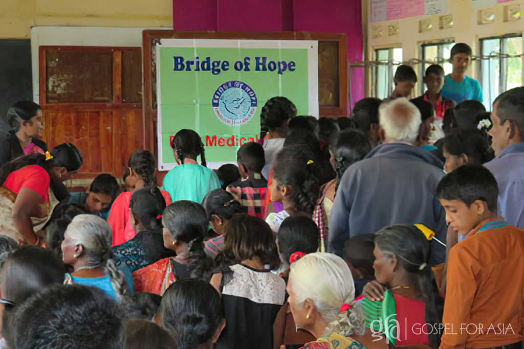 Discussing struggles with poverty, illnesses brought about by malnutrition, and the medical care brought near by Gospel for Asia Bridge of Hope.